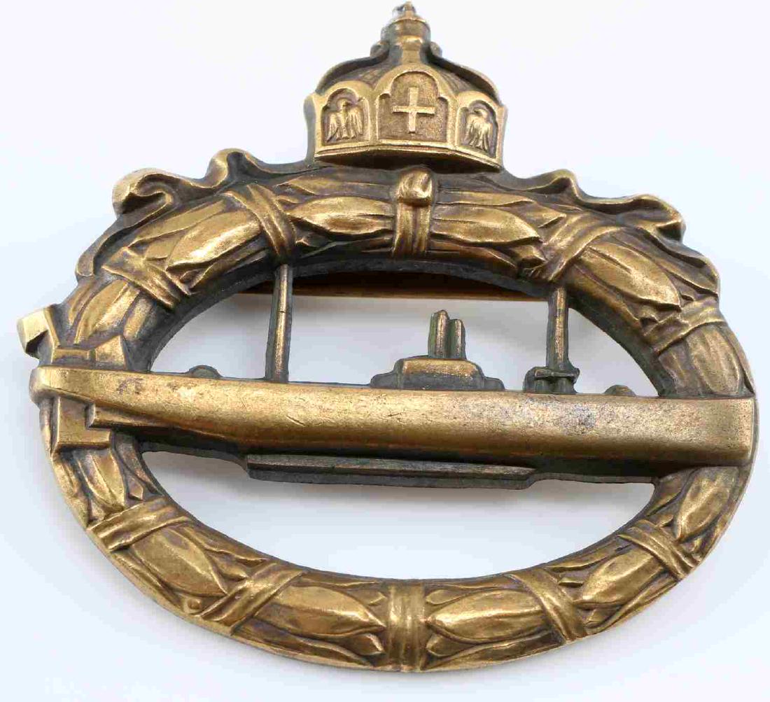 WWI IMPERIAL GERMAN BRONZE U BOAT BADGE: German WWI enlisted type U-Boat Badge with gilt brass cut-out of a U-boat on an open oak leaf oval wreath. Hohenzollern crown at the top. Reverse maker marked "WALTER SCHOTT Fec.". Flat horizontal pin