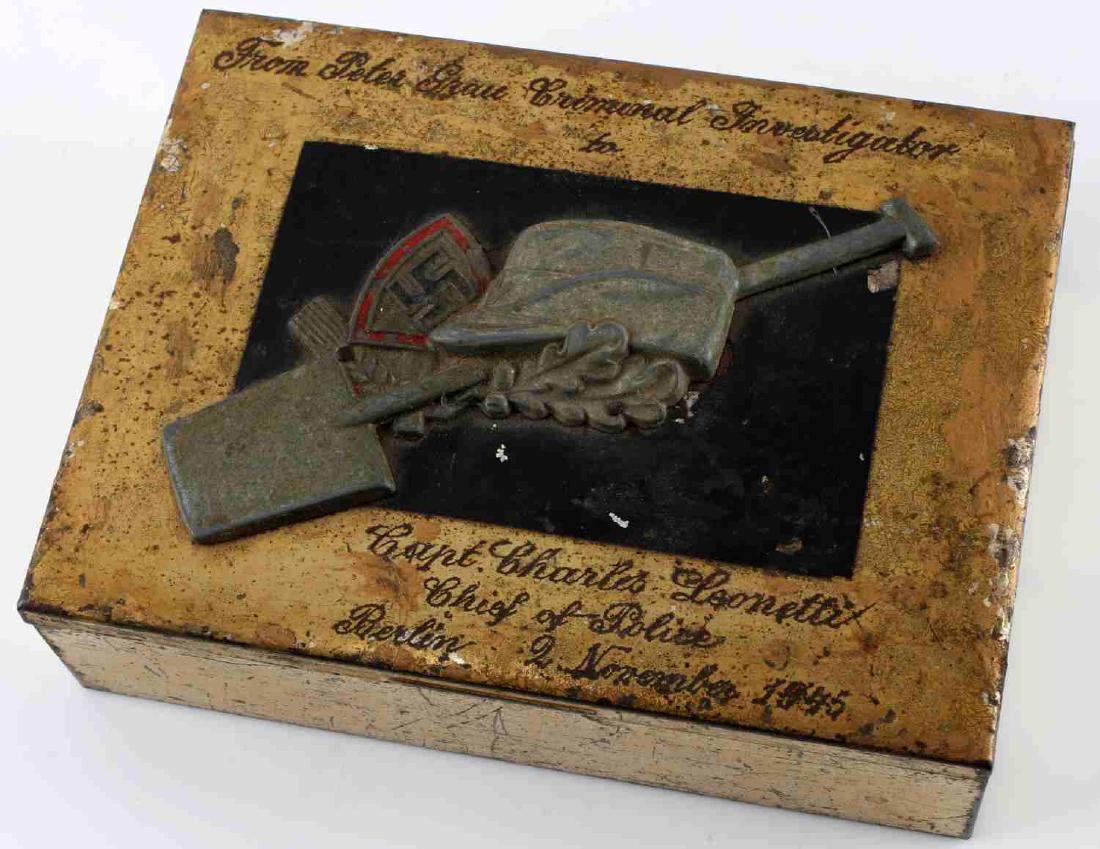 WWII GERMAN THIRD REICH RAD POLICE CIGAR BOX: This is a brass presentation cigar box with German RAD swastika/shovel designs. It measures 6" X 4.5". Engraved on the piece is "From Peter Grau Criminal Investigator to Capt. Charles Leonetti Chief o