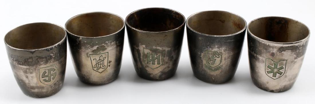 WWII GERMAN THIRD REICH WAFFEN SS SCHNAPPS CUP LOT: Lot of five silver plated schnapps cups, each bearing the crest of a Waffen-SS division. Includes LAH, Hitlerjugend, Nord, Das Reich, and Wiking. Each measures 1 1/4 inches in height. In very good con