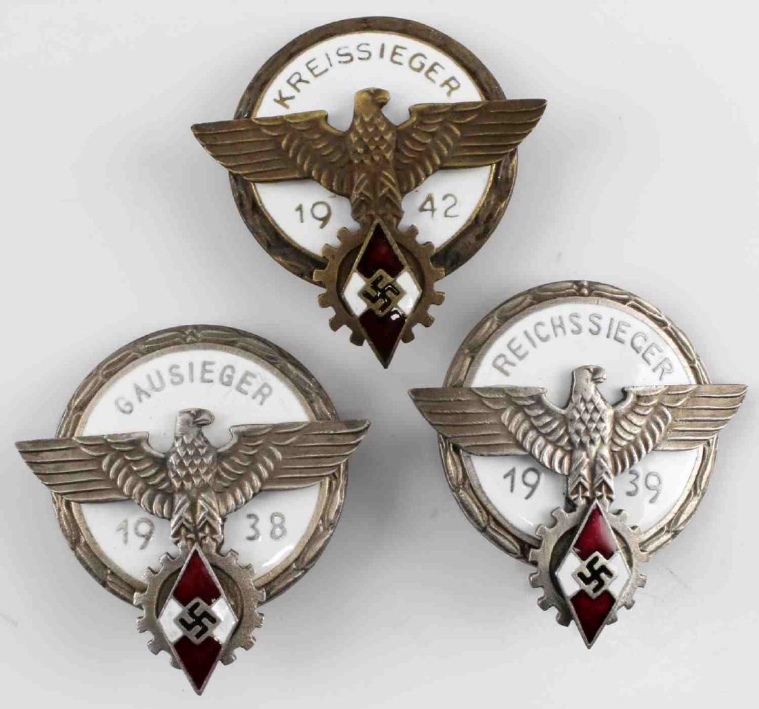 GERMAN WII THIRD REICH HITLERJUGEND BADGE LOT: German WWII Third Reich Hitlerjugend badge lot. Reverse maker marked "G Brehmen Markieukirchen" and "Agtham Gablonzan". Very good condition. Unauthenticated, sold "as is". This lot has a reserve.