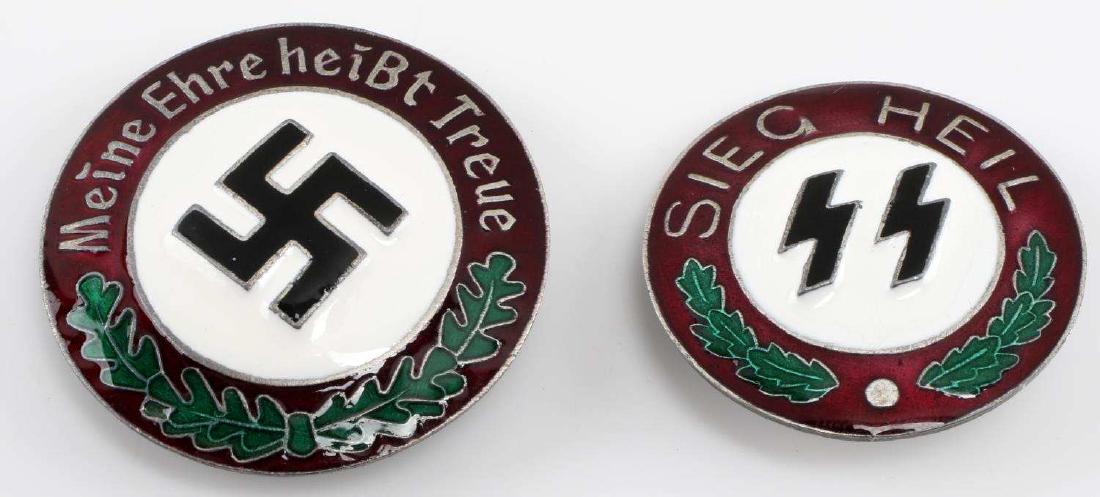WWII GERMAN THIRD REICH SS NSDAP BADGE LOT OF TWO: Lot of two SS badges. One has sig runes and 'Sieg Heil' written around it, while the other has a swastika and 'Meine Ehre heist Treue' around it. Each badge RZM markings. In very good condition. Unaut