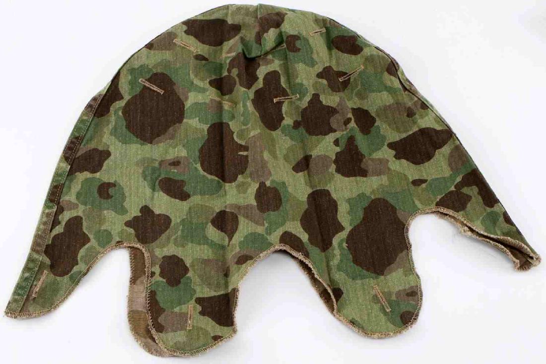 WWII US MARINE CORPS CAMOUFLAGE M1 HELMET COVER: Reversible camouflage cover for an M1 helmet. Has slots on sides for adding additional camouflage. Herringbone twill pattern. Very good condition.