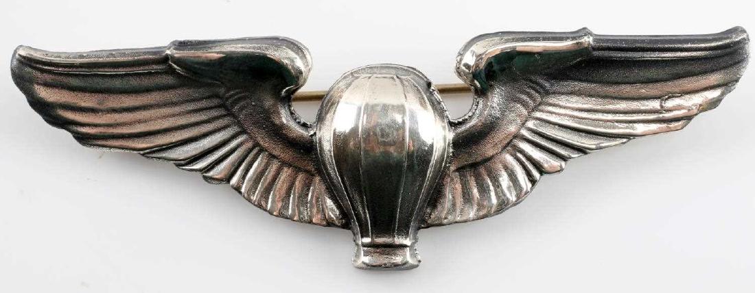 USAAF WWII ARMY AIRFORCE BALOON PILOT WING BADGE: USAAF WWII Army Air Force Balloon Dirigible Pilot wing badge pin. Measures 3 3/16 inches wide by1 inch tall. Reverse is maker mark "Meyer New York" and "Sterling". One piece silver construction.