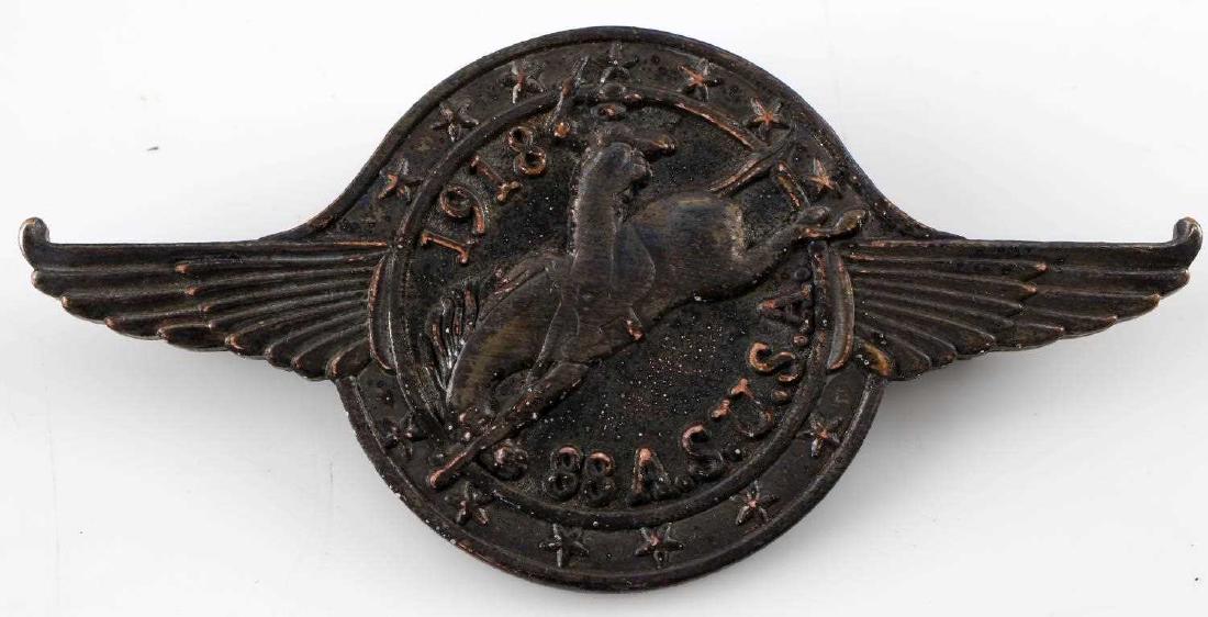 WWI US 1918 88TH AEF AERO AVIATION SQUADRON BADGE: US World War I 1918 AEF 88th Aero Aviation Squadron Badge. Measures 2.25 inches wide by 1 1/16 inch tall. The font reads "1918 88 A.S. U.S.A." The center shows a cowboy riding a bucking bronco horse w