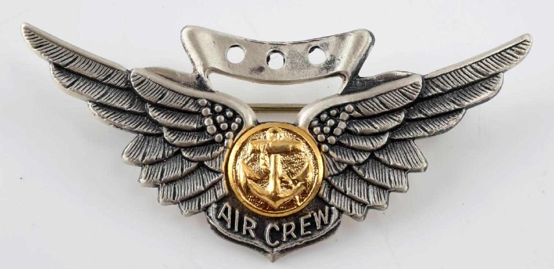 USA VIETNAM ERA NAVAL AIR CREW MEMBER WING BADGE: USA Vietnam era naval air crew member wings. Measures 2 inches wide by 7/8 inches tall. The front reads 'Air Crew' with an anchor in the center flanked by a wing on each side. The reverse is maker mar