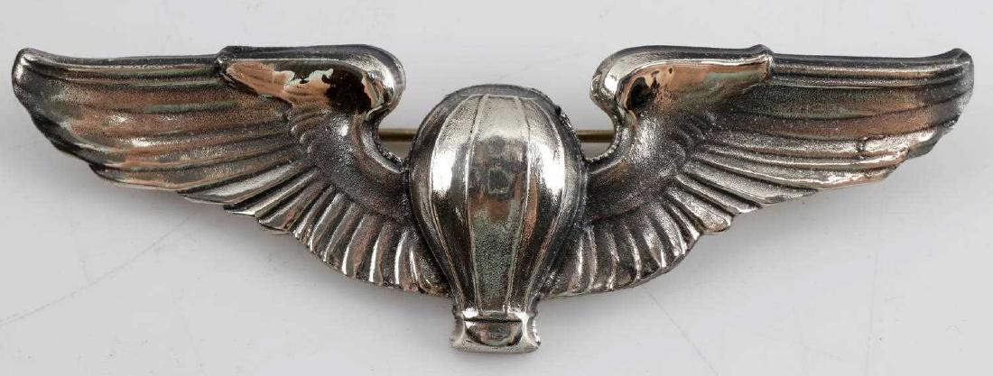 USAAF WWII ARMY AF BALLOON PILOT WING STERLING: Balloon to center flanked by wing on each side. Reverse marked Sterling with shield (for Meyer New York). Horizontal pin back with locking catch. Measures 3 3/16 inches wide X 1 inch tall. One piece s