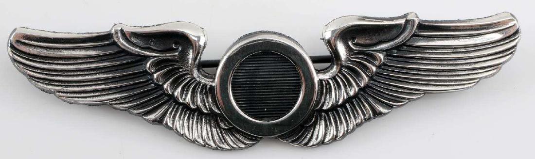 WWII UNITED STATES AIR FORCE OBSERVER WING BADGE: USAF Observer Wings. Reverse marked Meyer New York with Shield logo. Thin horizontal pin back with locking catch. One piece nickel construction. Very good condition overall. Sterling silver. Tests pos