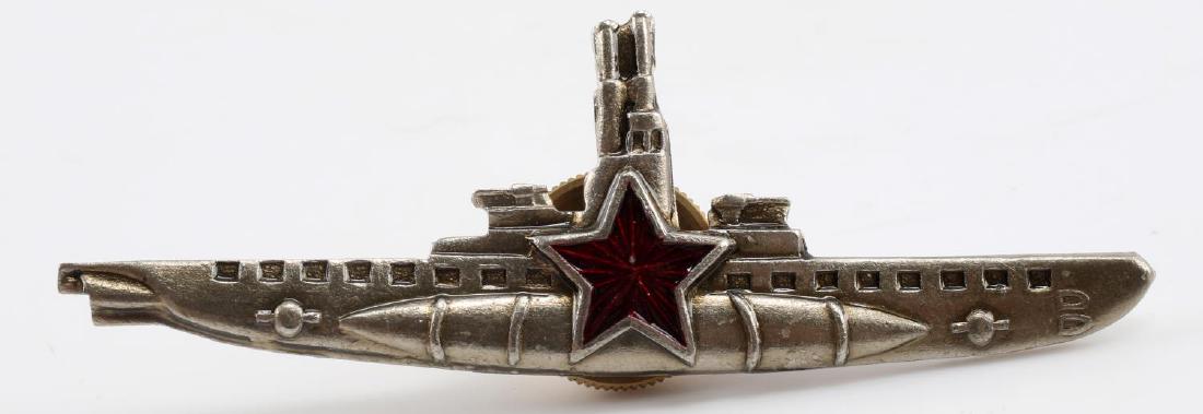 WWII SOVIET RUSSIAN SUBMARINE EM BREAST BADGE: Soviet Union Submarine Breast Badge. Screw mount post and nut on reverse. One piece nickel construction with enamel. For an enlisted man. Measures 2 5/8 X 7/8". Excellent condition with very limited s