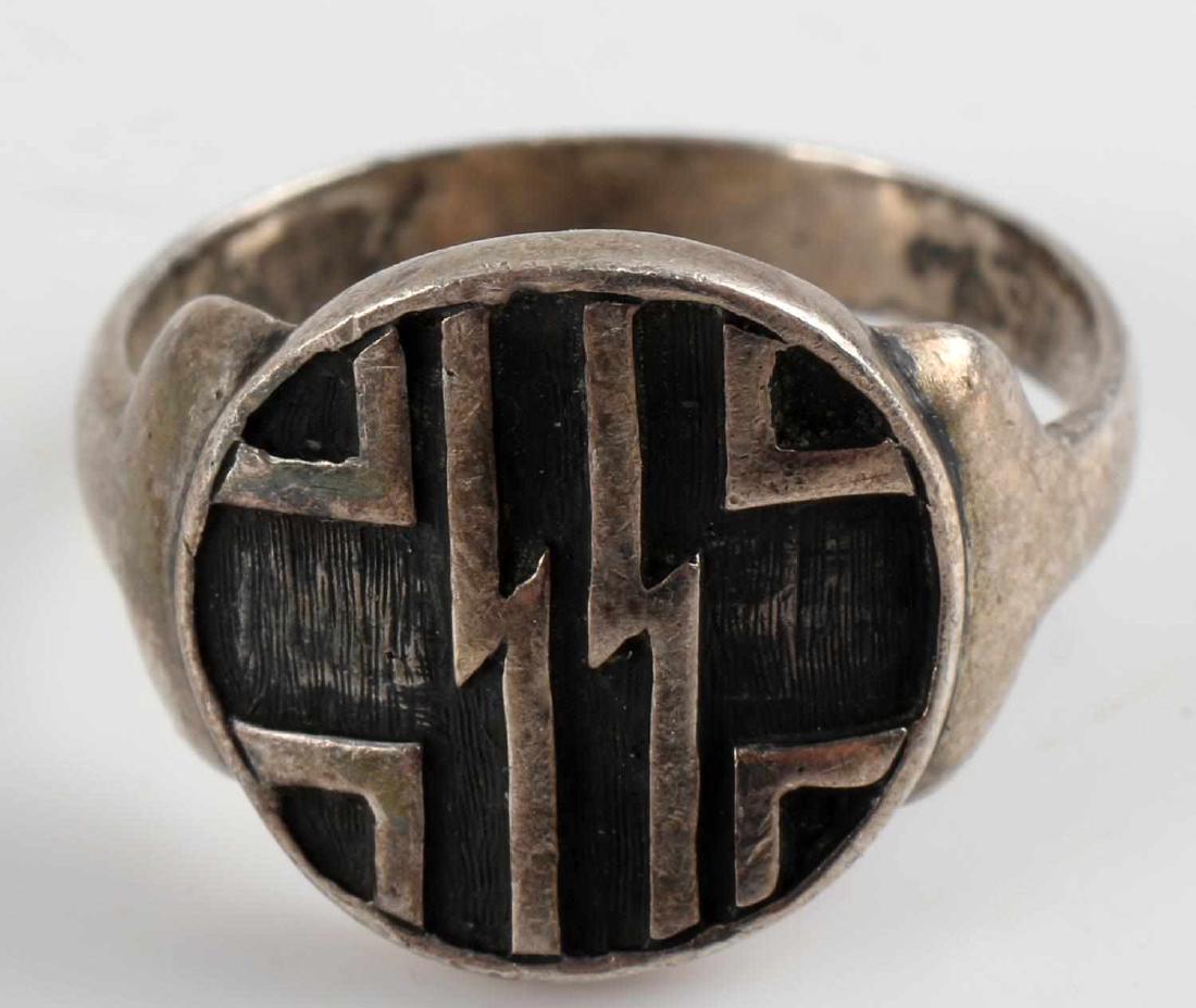 WWII GERMAN WAFFEN SS SCHUTZ STAFFEL OFFICERS RING: German SS Officers ring. Double S sig runes over German cross on obverse. Nickel construction. Very good condition overall with some patina present. Retains good detail. Ring size: 10.25.
