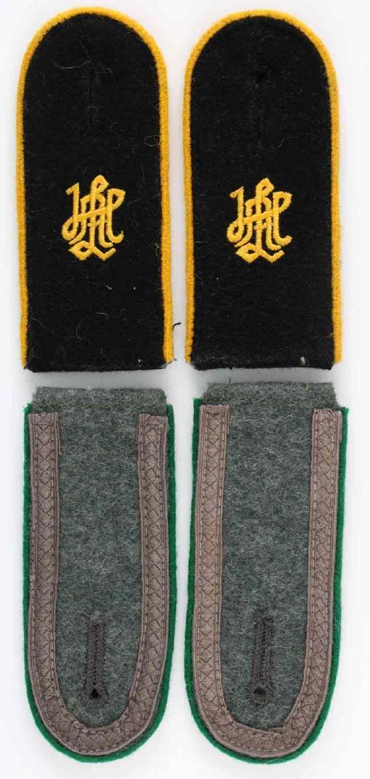 WWII GERMAN WAFFEN SS & HEER SHOULDER BOARD LOT: Lot of two sets of German shoulder boards. One is black wool with yellow cavalry piping and the LSSAH cypher. The other is a green wool with Jaeger green piping and Unteroffizier ribbon. In very good 