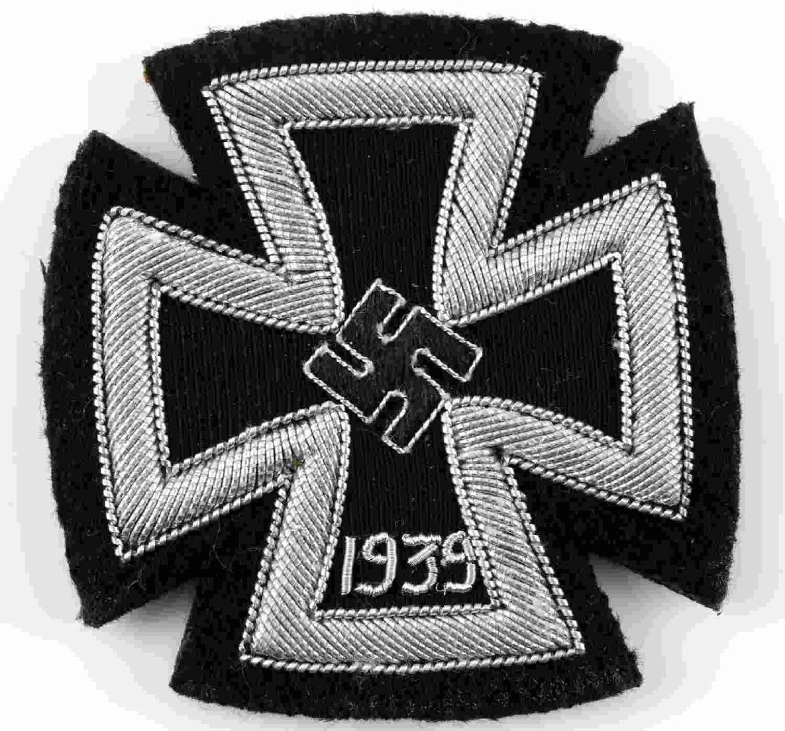 WWII GERMAN THIRD REICH IRON CROSS 1ST CLASS PATCH: Cloth patch with the image of the Iron Cross 1st Class upon it. Silver bullion wire of two different gauges, with a more common narrow gauge wire on the '1939' and much more broad wire for the rest of