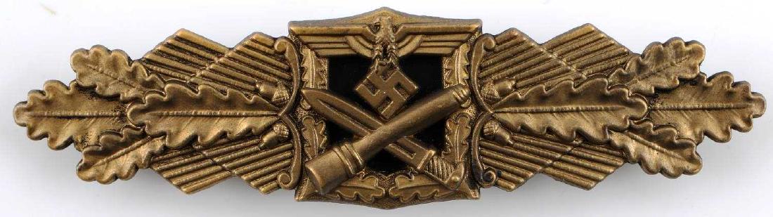 GERMAN WWII ARMY WEHRMACHT GOLD COMBAT CLASP: Depicts Army eagle with a crossed stick grenade and bayonet below. Flanked by oak leaves. Reverse is marked "Fec W E Peekhaus Berlin FLL". Wide horizontal pin back. Awarded for 50 days close combat. V