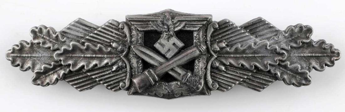 GERMAN WWII ARMY SILVER CLOSE COMBAT CLASP: Army eagle with crossed stick grenade and bayonet below. Flanked by oak leaves. Reverse is marked "Fec W E Peekhaus Berlin FLL." Wide horizontal pin back. Awarded for 30 days close combat. very good c