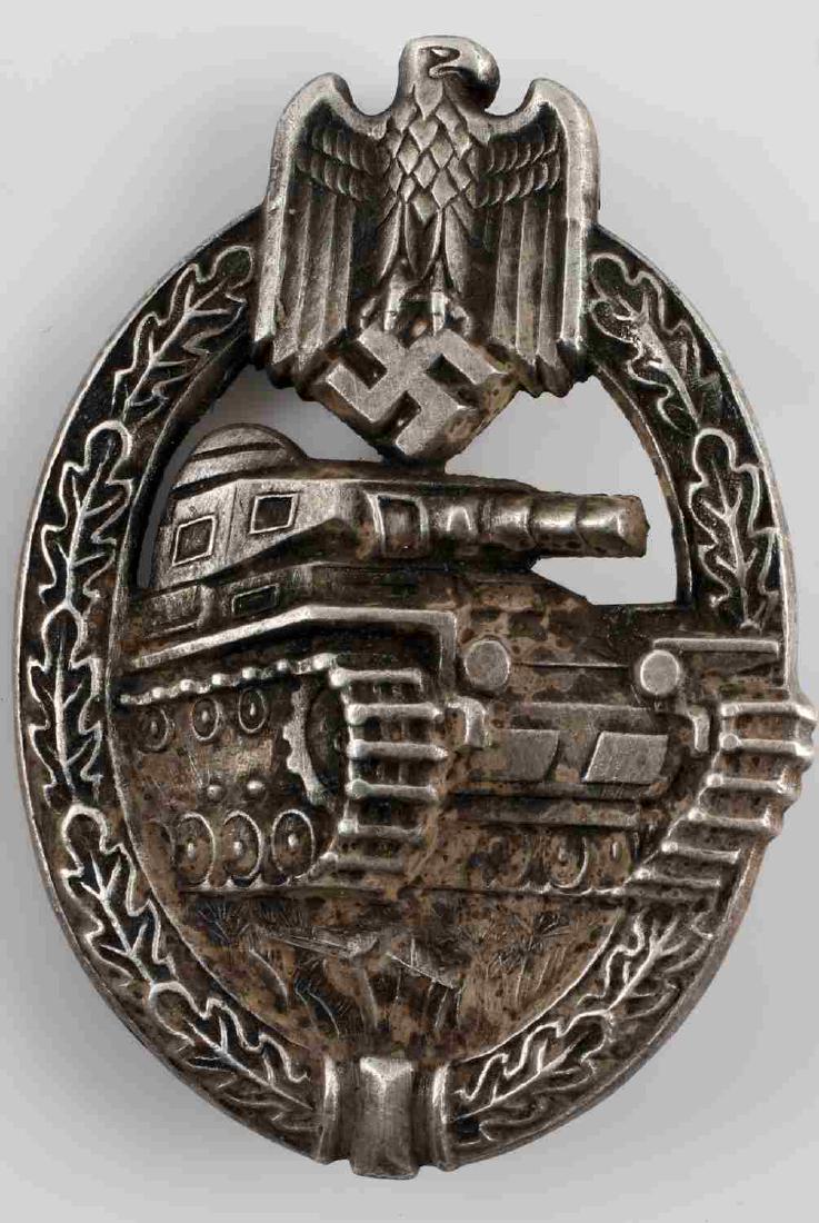 WWII GERMAN 3RD REICH SILVER PANZER ASSAULT BADGE: German silver Panzer Assault badge with tank and Reichsadler reverse surrounded by oval oak leaf wreath. The reverse is maker marked "HA" for Herman Aurich. Thin vertical pin back and solid-type nicke