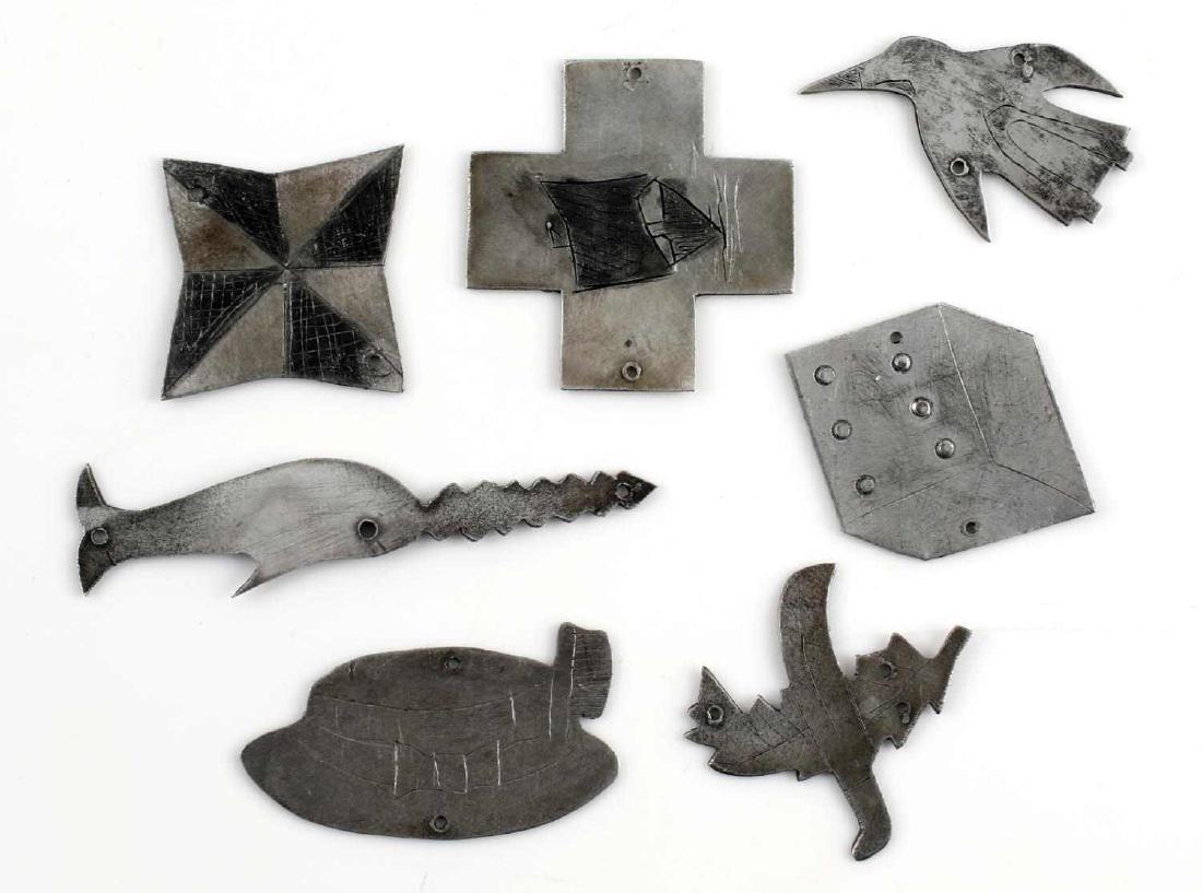 GERMAN 3RD REICH KRIEGSMARINE U BOAT CAP BADGE LOT: Lot of seven aluminum badges believed to be for attaching to the caps of U-Boat crewmen. Include saw fish, hat, penguin, dice, cross, scarecrow, and shield. In very good condition. Unauthenticated/Sol