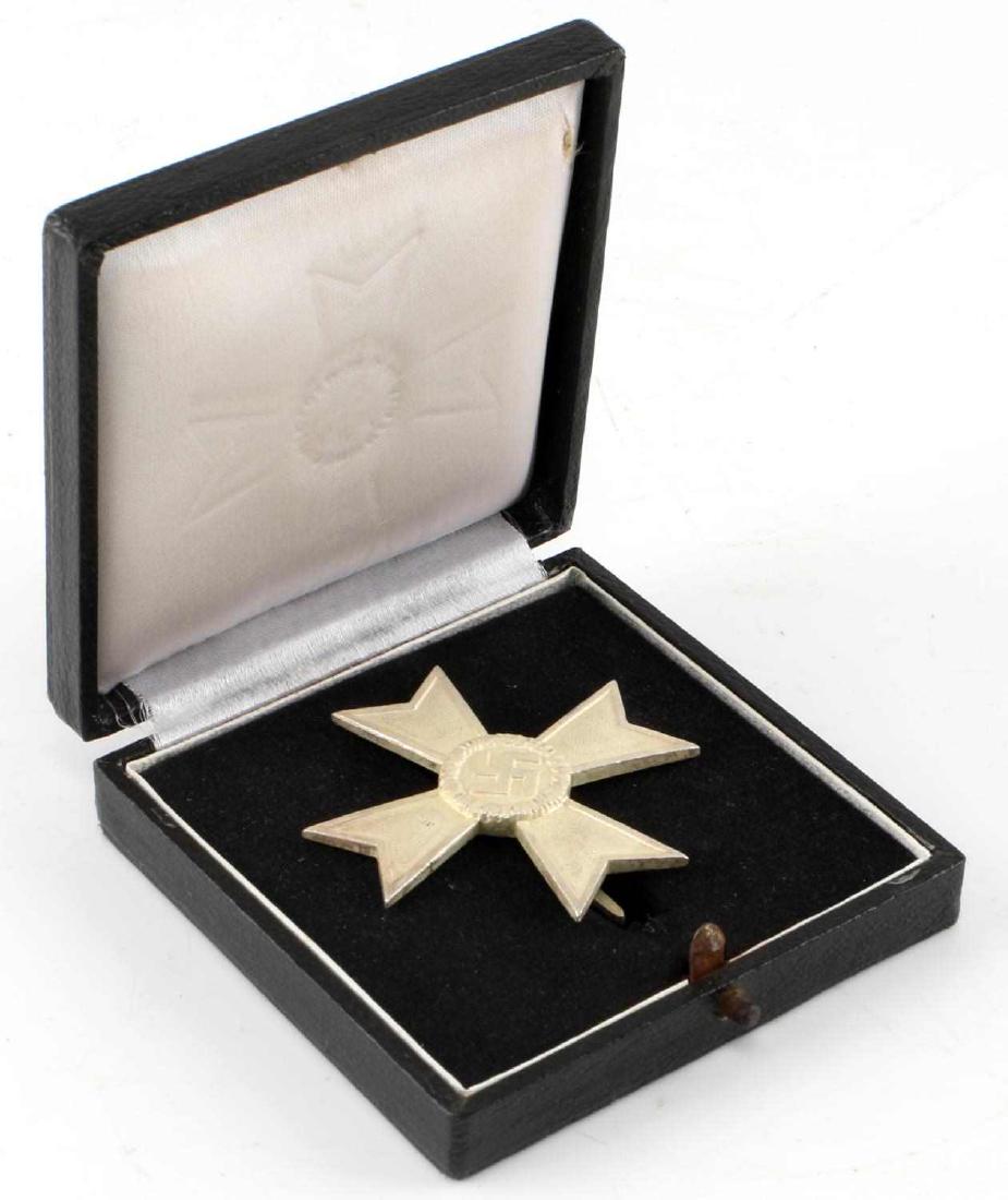 WWII GERMAN 3RD REICH WAR MERIT CROSS 1ST CLASS: War Merit Cross 1st Vlass medal without sword, in black leatherette case. Wide vertical pin back with '1' mark. Silver-plated nickel construction. Very good condition.