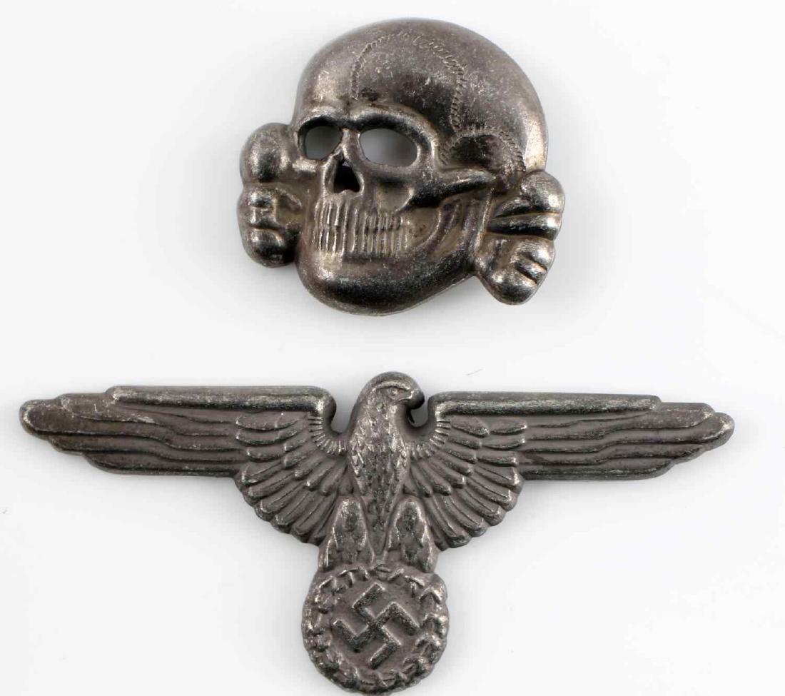 GERMAN WWII THIRD REICH VISOR PIN EAGLE AND SKULL: German WWII Waffen SS visor cap eagle and skull pins. Both maker marked "RZM M1/52". Stamped nickel construction. Very good condition.