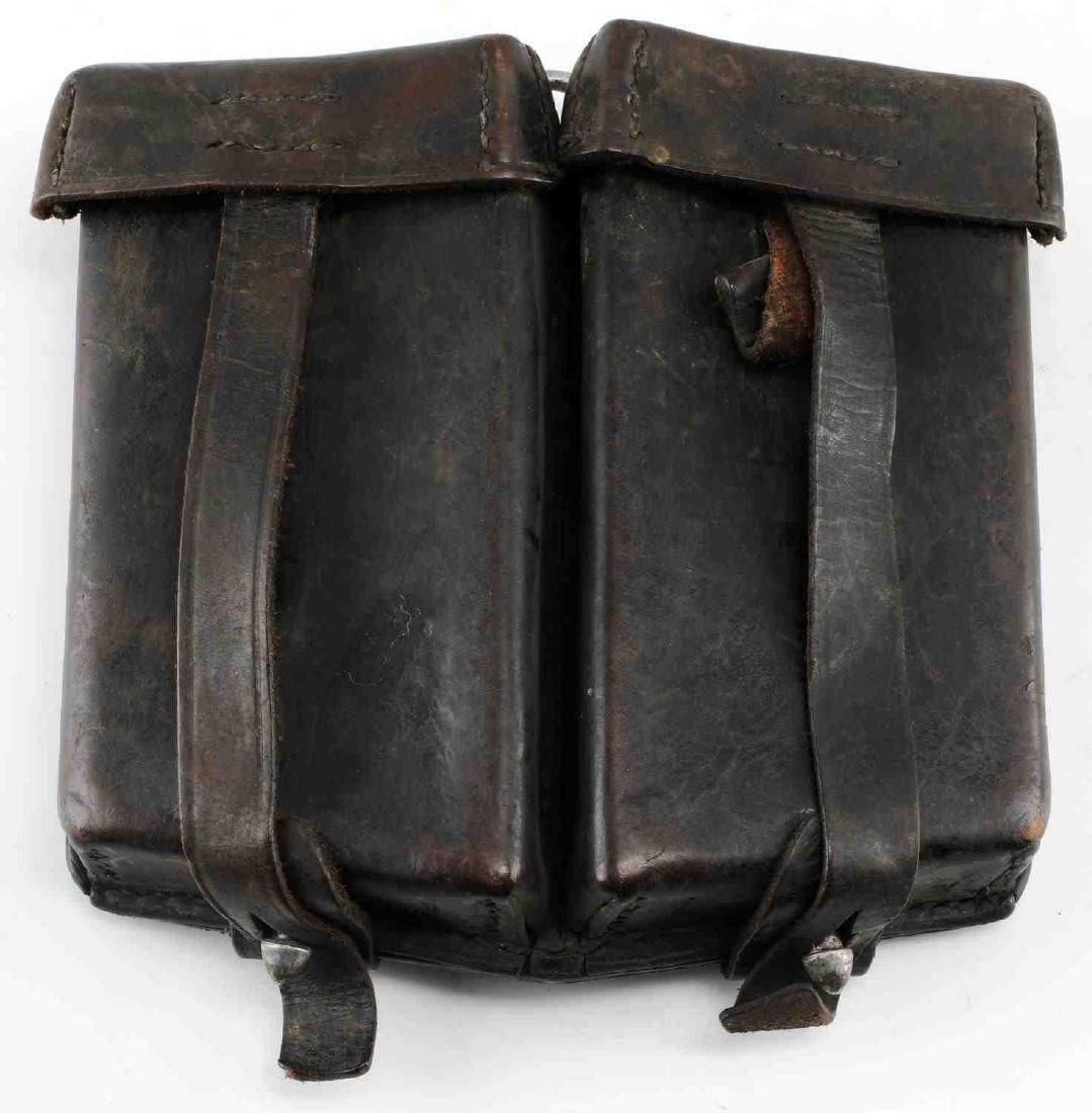 WWII GERMAN WAFFEN SS MACHINE GUN CLIP POUCH: German SS Leather Machine Gun Clip Pouch. Reverse marked "C. Riese Berlin." and stamped with double S sig runes. Multi piece machine sewn black leather construction. Holds two MG clips. Very good cond