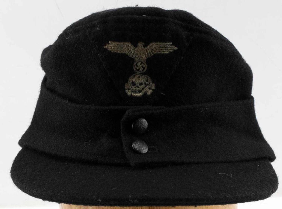 WWII GERMAN WAFFEN SS PANZER M 43 COMBAT FIELD CAP: German Waffen SS Panzer field cap. Black wool material with SS machine embroidered eagle and totenkopf trapezoid sewn to front. Grey cotton interior lining. Medium size. For an enlisted man. Ink stamp