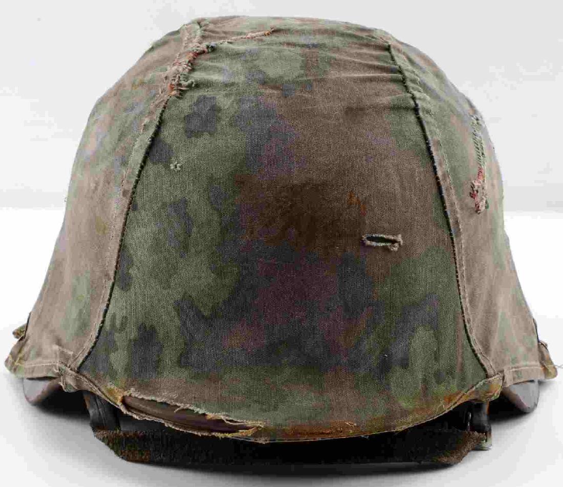 GERMAN WWII THIRD REICH M40 COMBAT HELMET: German WWII Third Reich M-40 Combat Helmet with SS Camoflauge Cover. Non Decal helmet with green paint, leather chin strap, and reversible liner. cover shows some wear. Very good condition.