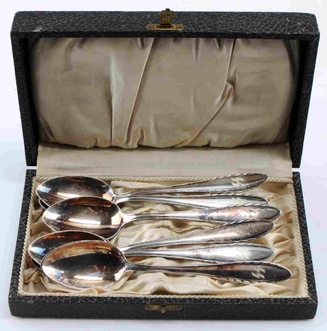 WWII GERMAN WAFFEN SS OFFICERS DEMITASSE SPOON SET: Cased German SS Officers spoon set. 5 3/8" long spoons with double S sig runes hand engraved on front base. The reverse sides are marked "CFH 90 18". Silver plated nickel construction. Comes with 6 5/