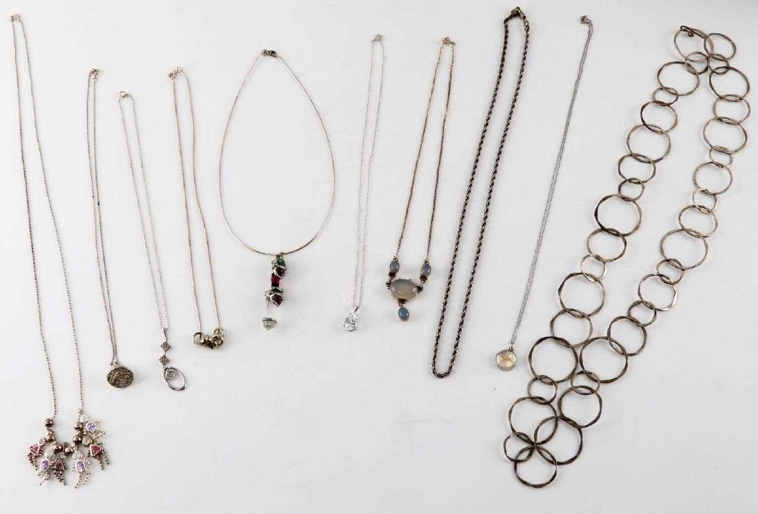 10 PIECE LOT STERLING SILVER NECKLACES & PENDANTS: 10 piece lot of sterling silver necklaces and pendants. One 29 inch necklace with six small girl and boy crystal pendants. One 20 inch necklace with decorative oval and diamond charm. 10.5 inch neckla