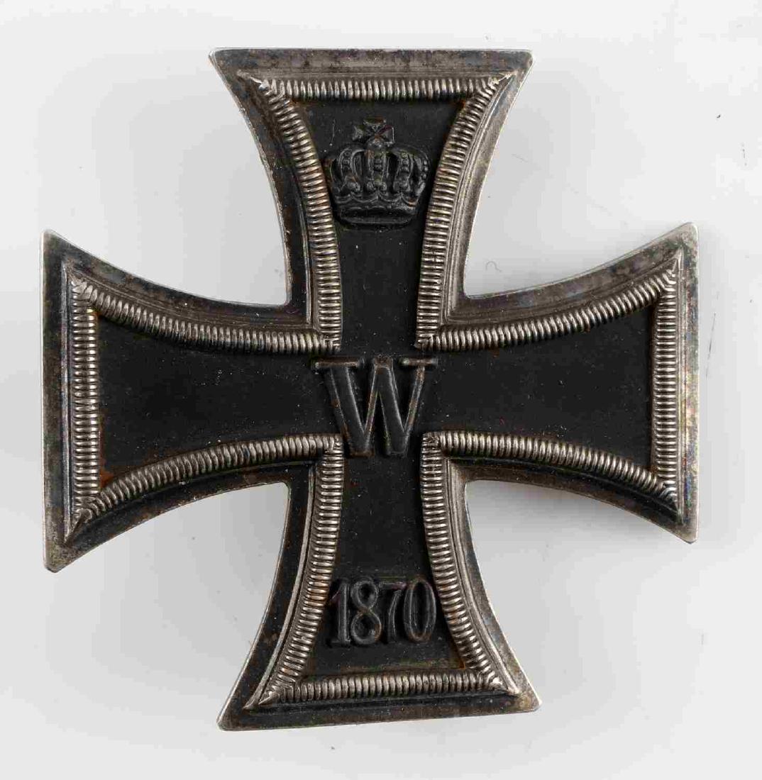 1870 FRANCO PRUSSIAN GERMAN FIRST CLASS IRON CROSS: German Franco-Prussian War Iron Cross. Silver boarder and magnetic core. Reverse marked "L. Wagner & S" and "14 Lotig". Thin vertical pin back. Very good condition with heavy patina present. This lot 