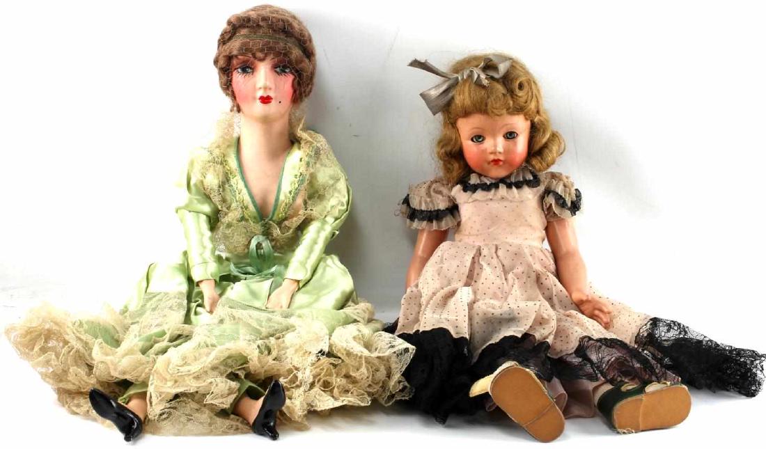 TWO PORCELAIN DOLLS EFFANBEE WITH ORIGINAL BOX: Lot of two porcelain dolls. One Effanbee doll with original box (missing lid). Style 8072. Doll has curled blonde hair and wears a pink and black dress with a bow in hair. Measures 21 inches in length