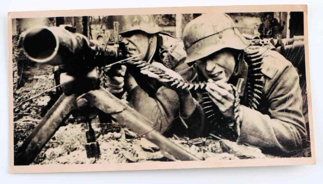 WWII GERMAN THIRD REICH WAR PHOTOGRAPHY 1943: WWII German Third Reich black and white war photograph of two men and a machine gun. Marked on back "Charkow, 1943" and stamped with "Waffen-Gresadier-Division" Measures approximately 6 inches by 3 in