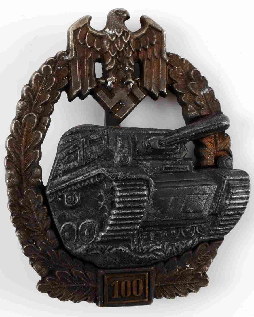 WWII GERMAN PANZER ASSAULT 100 ACTION BADGE: This is a 2 pc construction and riveted 100 action panzer assault badge. It is reverse marked "JES" in a square. Very good condition overall with some moderate patina and service wear. Some of the gil