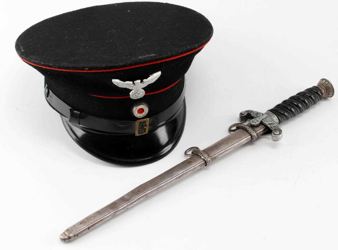 WWII GERMAN RAILWAY DAGGER & VISOR CAP LOT OF 2: This lot includes 1 German Railway (Deutsche Reichsbahn) dagger and 1 Railway visor cap. Dagger marked Solingen with Solingen squirrel icon on its ricasso. Cap is unmarked but has a name inked on the 