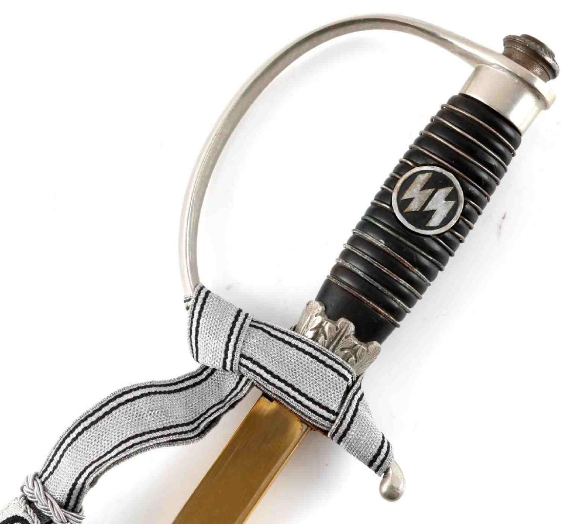 WWII GERMAN WAFFEN SS OFFICER DEGEN SWORD: German SS Officer Degen by Paul Weyersberg. Complete with superb blue and gold Weyersberg SS blade with SS motto and Himmler signature facsimile. Also includes standard SS sword knot. Pommel nut featu