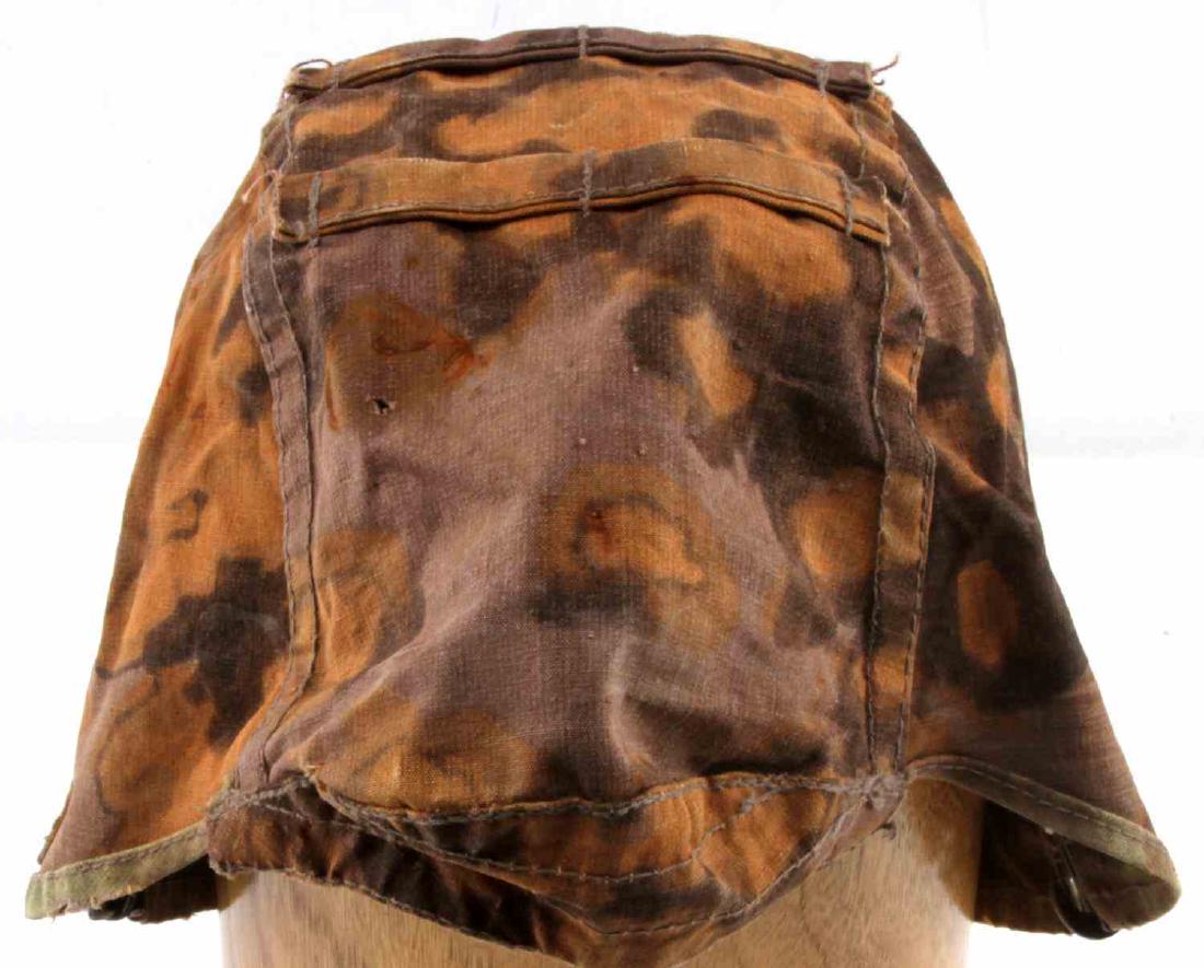 WWII GERMAN WAFFEN SS REVERSABLE HELMET COVER: WWII German Waffen SS 2nd pattern helmet cover made with heavy cotton construction with loops for additional camouflage on front, back, and sides. It has spring loaded aluminum clips for attaching to 