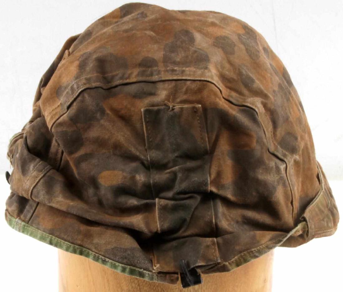WWII GERMAN WAFFEN SS REVERSABLE HELMET COVER: WWII German Waffen SS 1st pattern helmet cover made with heavy cotton construction with loops for additional camouflage on front, back, and sides. It has spring loaded aluminum clips for attaching to 