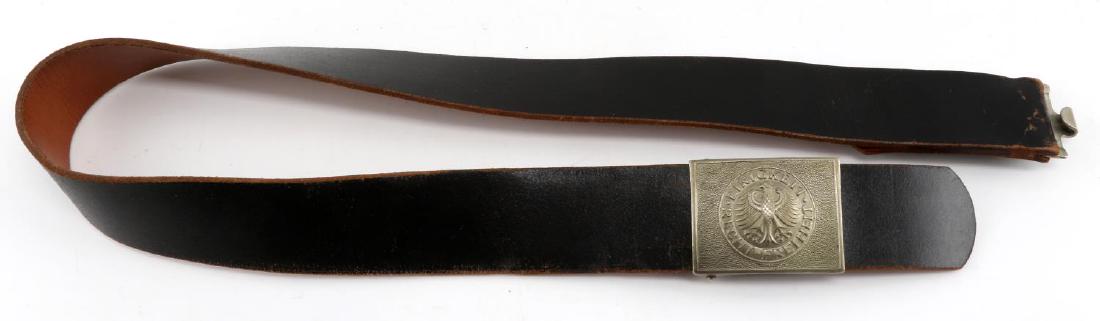POST WWII WEST GERMAN EM BELT AND BELT BUCKLE: Post WWII West German EM Belt. German Eagle with "Einigkeit- Freiheit-Recht on buckle. Stamped size 100 on belt. Leather and aluminum construction. Very good condition with some leather wear and patin
