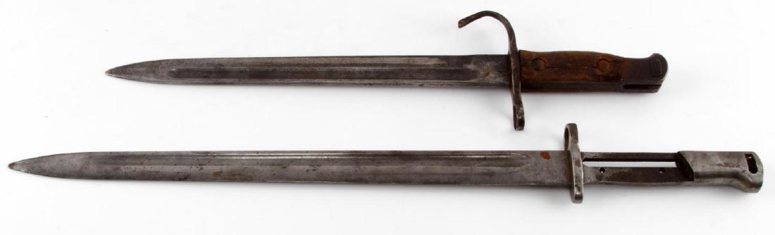 LOT OF 2 BAYONETS W JAPANESE TRAINER & UNKNOWN: Japanese trainer bayonet has curved guard and loss of wood grip. The other bayonet measures 20 inches long with a 15 inch blade, only marking is number to fitting (2123-R) and grip is missing. EW49, E