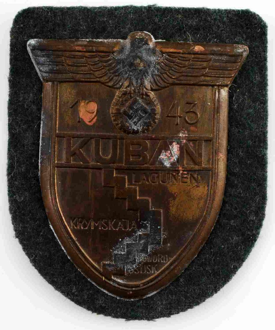 WWII GERMAN THIRD REICH KUBAN CAMPAIGN SHIELD: WW2 German 1943 Kuban Campaign Shield. Bronze metal mounted on green wool with 4 prongs through steel backplate with paper backing. Awarded to those who fought at the Kuban bridgehead in the Soviet Un