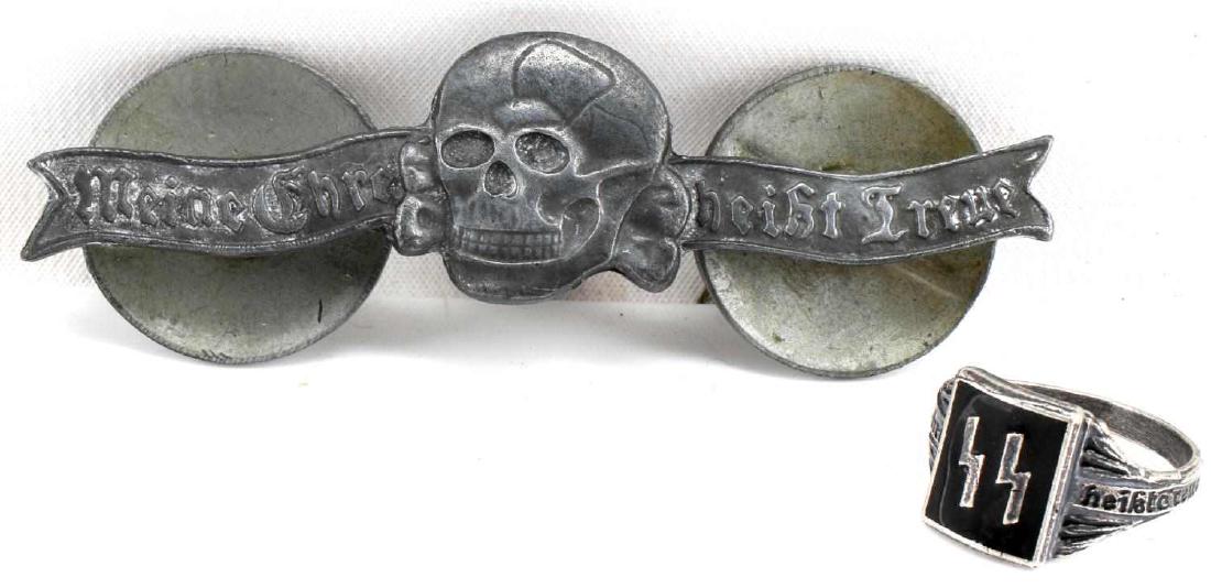 WWII GERMAN WAFFEN SS RING & LARGE BADGE LOT OF 2: This lot features 1 enameled and silver SS ring with "Meine Ehre Heisst Treue" motto on band and enameled double S sig runes on front. Lot also includes 1 large "Meine Ehre heisst treue and totenkopf 