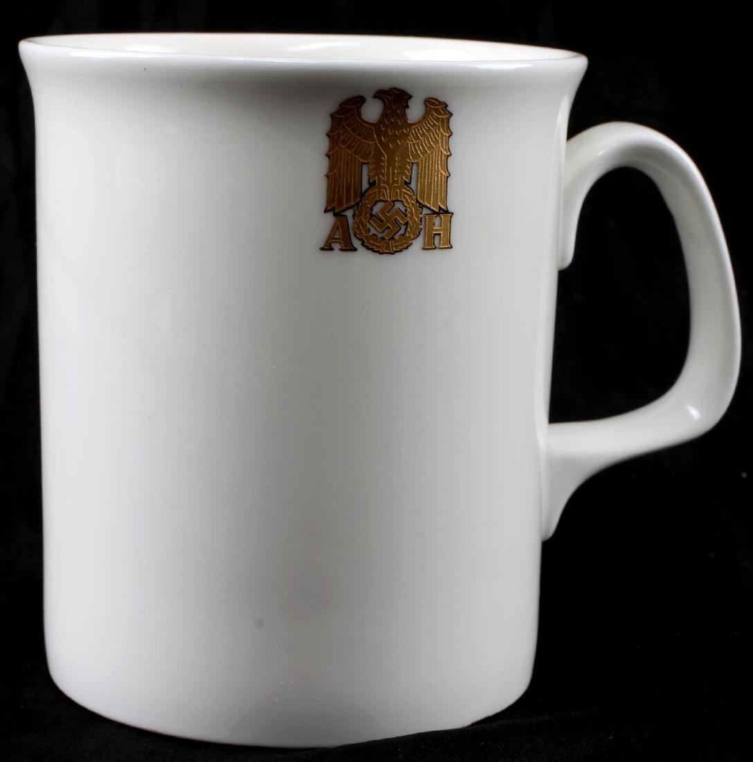 GERMAN THIRD REICH ALLACH PORCELAIN HITLER CUP: Porcelain coffee cup with the formal gold 'AH' Reichsadler mark of Hitler. The bottom is marked with the Allach maker mark. Brought to the US by a member of the 506th PIR. In very good condition. CSG