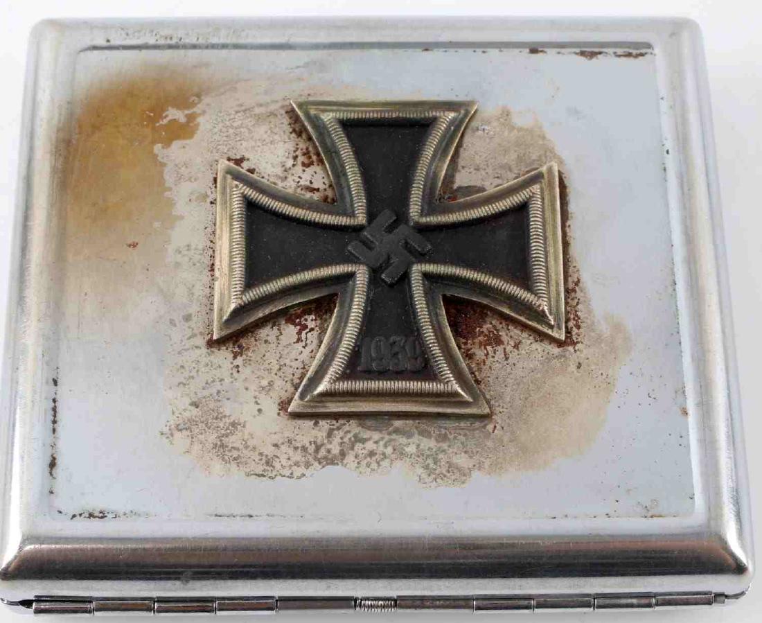 GERMAN WWII IRON CROSS WINNERS CIGARETTE CASE: Iron cross affixed to front. Some rust around cross. Measures 3.25 X 3.25 inches. No maker's mark. Unauthenticated, sold as is. This item has a reserve.
