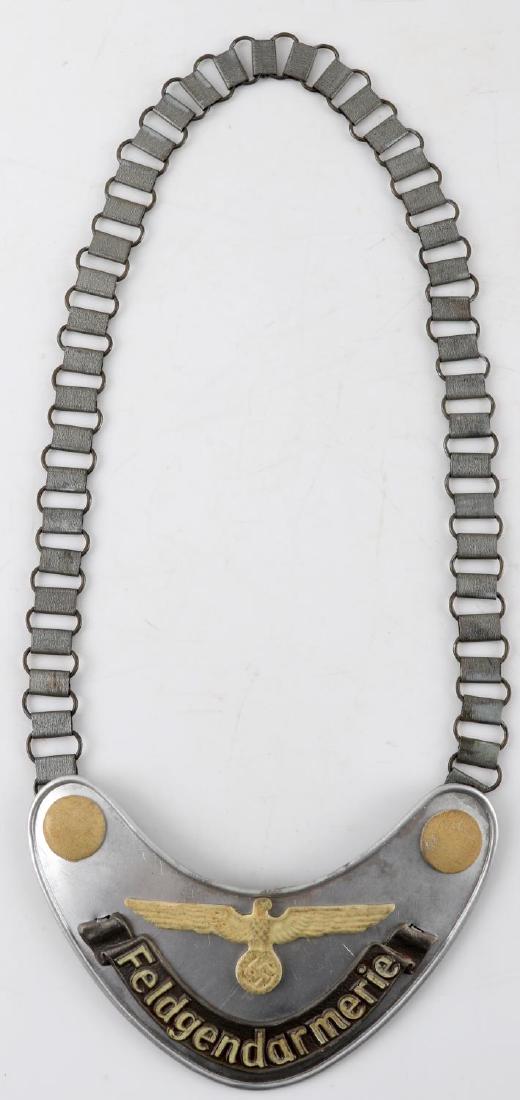 GERMAN WWII ARMY FIELDZHANDARM GORGET WITH CHAIN: Aluminum construction with 'Feldgendarmerie' with eagle to front, RZM M34/2 marked to back, wool backing. Measures 15.75 X 6.5 inches. Very good condition. Unauthenticated, sold as is. This item has a