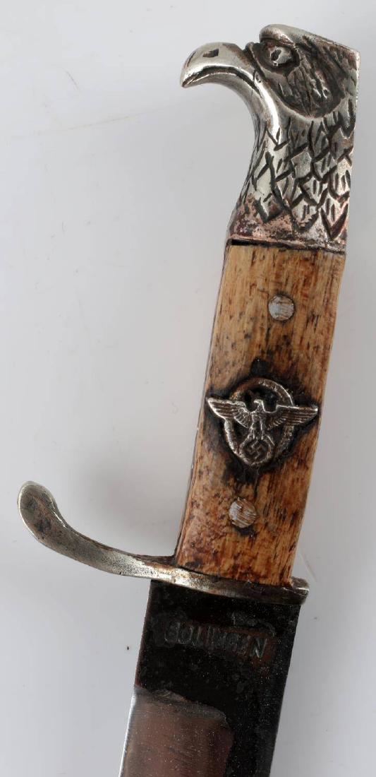 GERMAN WWII SS POLICE MINI BAYONET BY SOLINGEN: Wood grips with German eagle inlay, bird's head pommel, 3.5 inch blade marked Solingen, steel scabbard with brass piece at opening. In scabbard, measures 6.5 inches long. Good condition. Unauthenticat