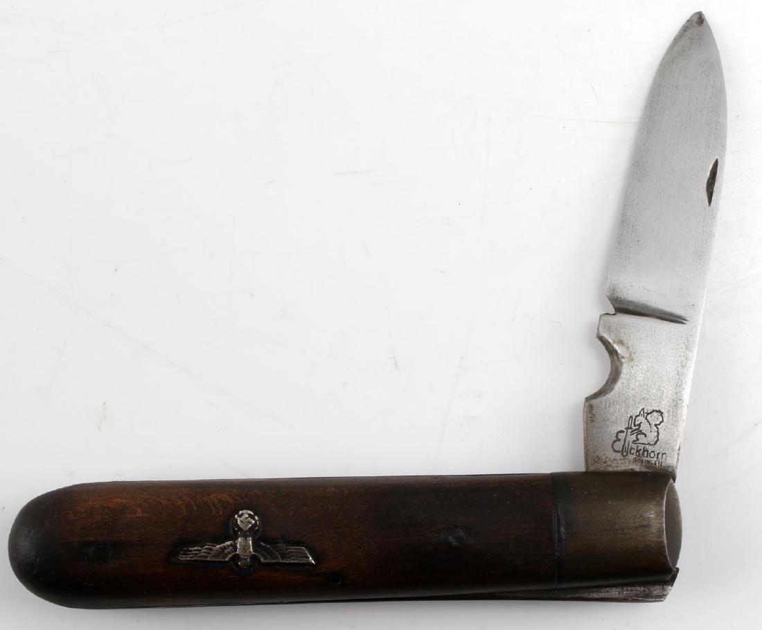 GERMAN WWII THIRD REICH EICKHORN SOLINGEN KNIFE: German WWII Third Reich Eickhorn Solingen Pocket Knife. Measures about 7 3/4 inches long while open. Blade is maker marked Eickhorn with Squirrel emblem. Folding steel blade construction with wooden h