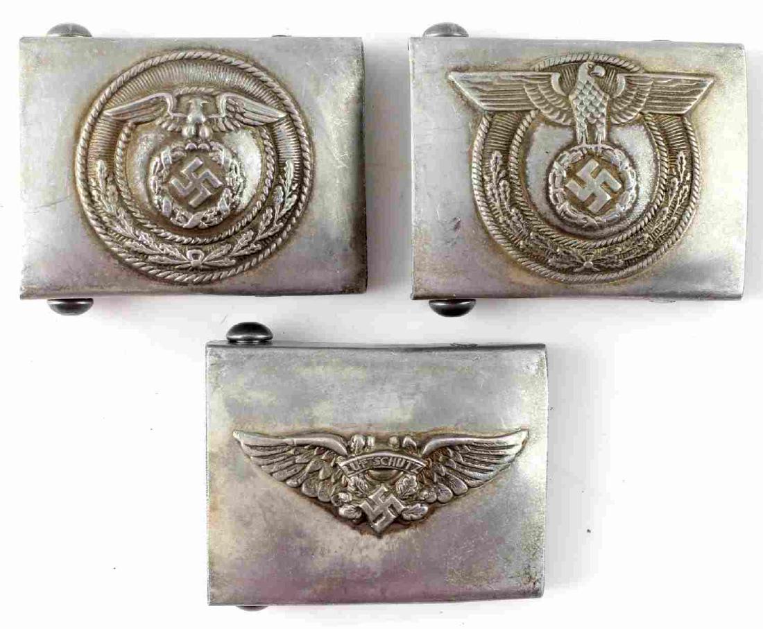 WWII GERMAN THIRD REICH BELT BUCKLE LOT OF THREE: Lot of three German belt buckles. One is SA, the second is Luftschutz, and the third is Police. All are in very good condition. All are marked RZM M34/2. This item has a reserve.