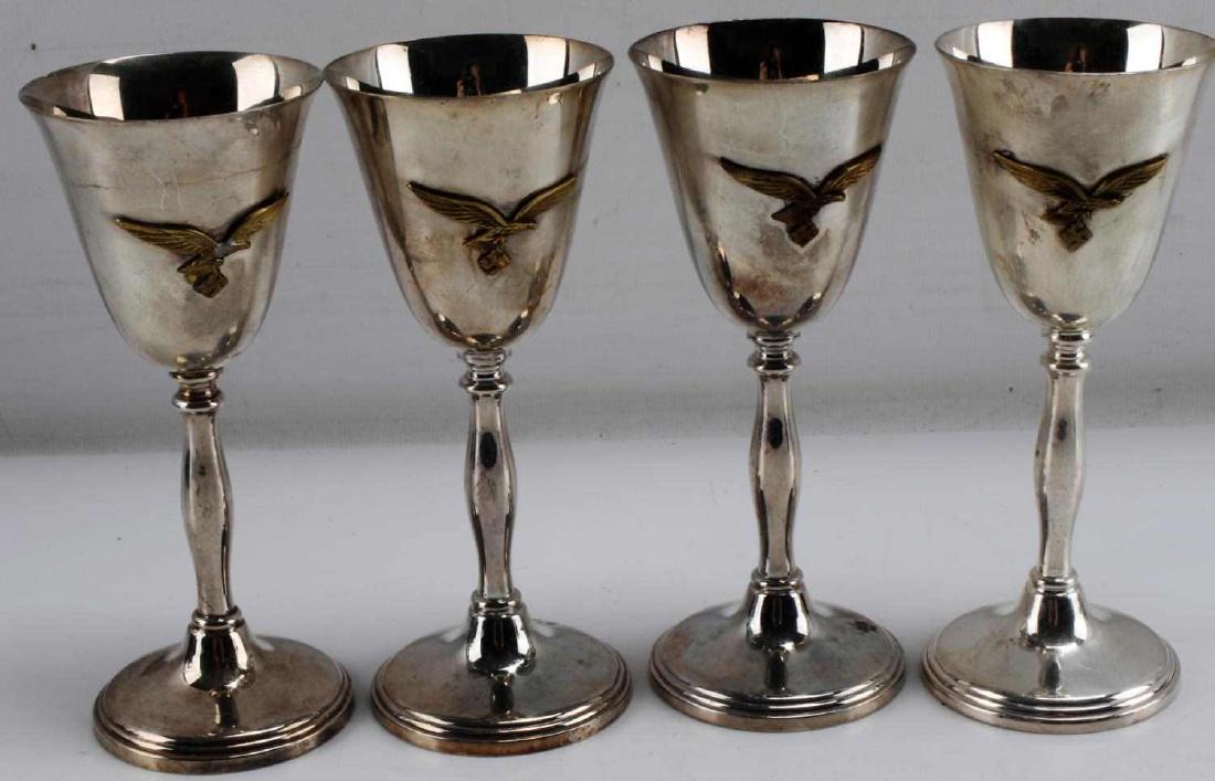 WWII GERMAN THIRD REICH LUFTWAFFE WINE GOBLET LOT: Lot of four small silver-colored wine goblets with Luftwaffe markings, likely from an officer's canteen. Each measures 6 inches in height. Unauthenticated/Sold 'as is' This item has a reserve.