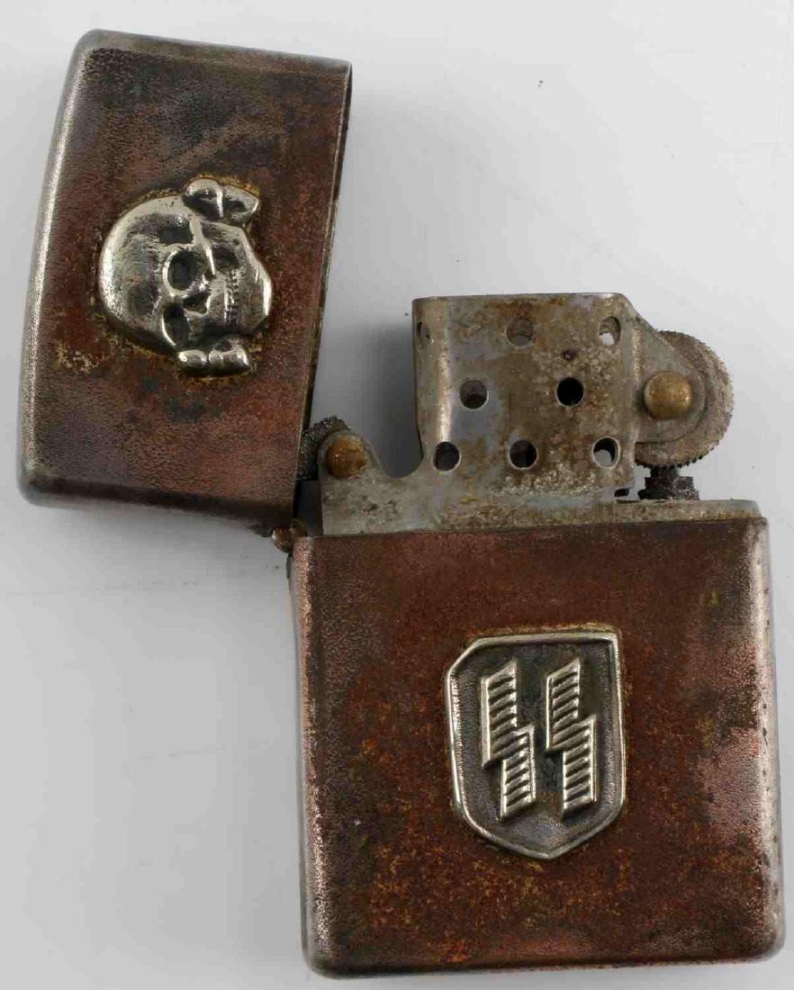 WWII GERMAN THIRD REICH WAFFEN SS LIGHTER: Cigarette lighter with Totenkopf and SS rune badges affixed. The inside portion of the lighter has a Reichsadler stamp as well. In very good condition. Unauthenticated/Sold 'as is' This item has a res
