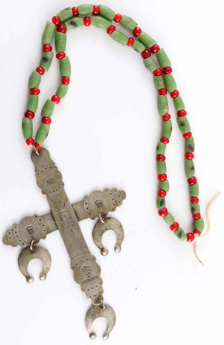 HUDSON BAY COIN SILVER TRADE CROSS W PERIOD BEADS: Hudson Bay coin silver trade cross. Has period green and red beads attached. Cross is stamped with filigree design throughout and with HB in in three places. Stamped Montreal with crown and roman nume