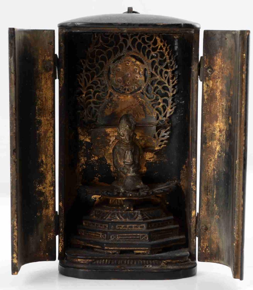 ANTIQUE TIBETAN TRAVEL PRAYER SHRINE HINDU PUJA: Antique carved, lacquered and gilded Tibetan Travel Prayer shrine or Hindu Puja with central deity figurine depicted in central bronze figurine in bronze adorned interior altar. Gilding and lacquer ha
