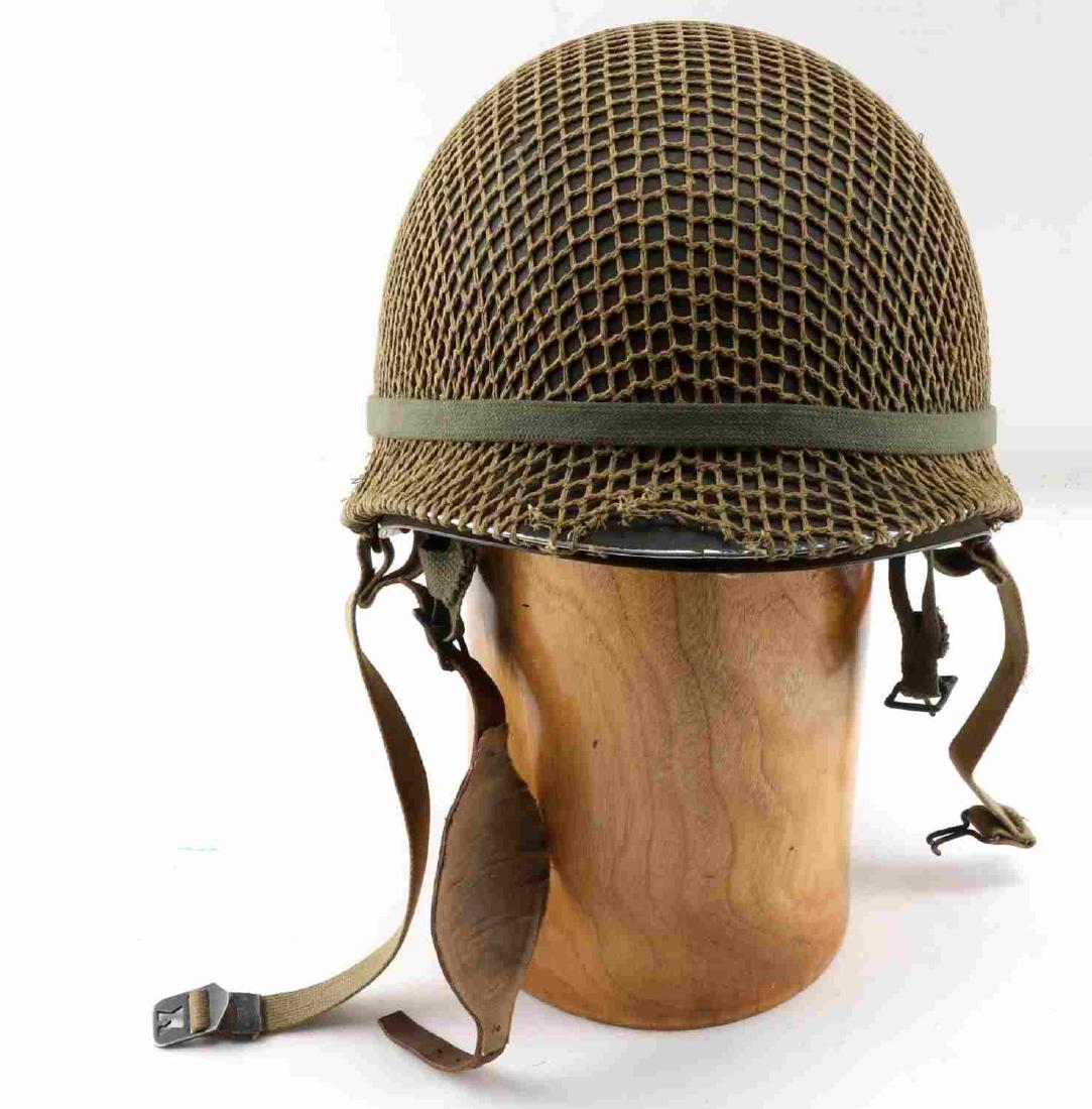 WWII US ARMY AIRBORNE PARATROOPER JUMP HELMET: US Paratrooper M1 helmet. Intact shell, liner, leather strap, and leather paratrooper chin cup. Camo net covers shell. WWII front seam version. Very good overall.