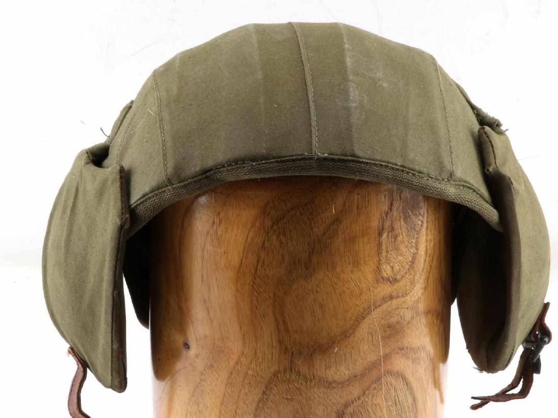 WWII US AIR FORCE AIR CREW M4A2 FLAK HELMET: air crew anti-flak helmet. O.D. cloth covered steel shell and hinged ear covers. Leather chinstrap and web snap tabs for securing headphones. Cloth lined. Original label "HELMET M4A2" "Industrial Canv
